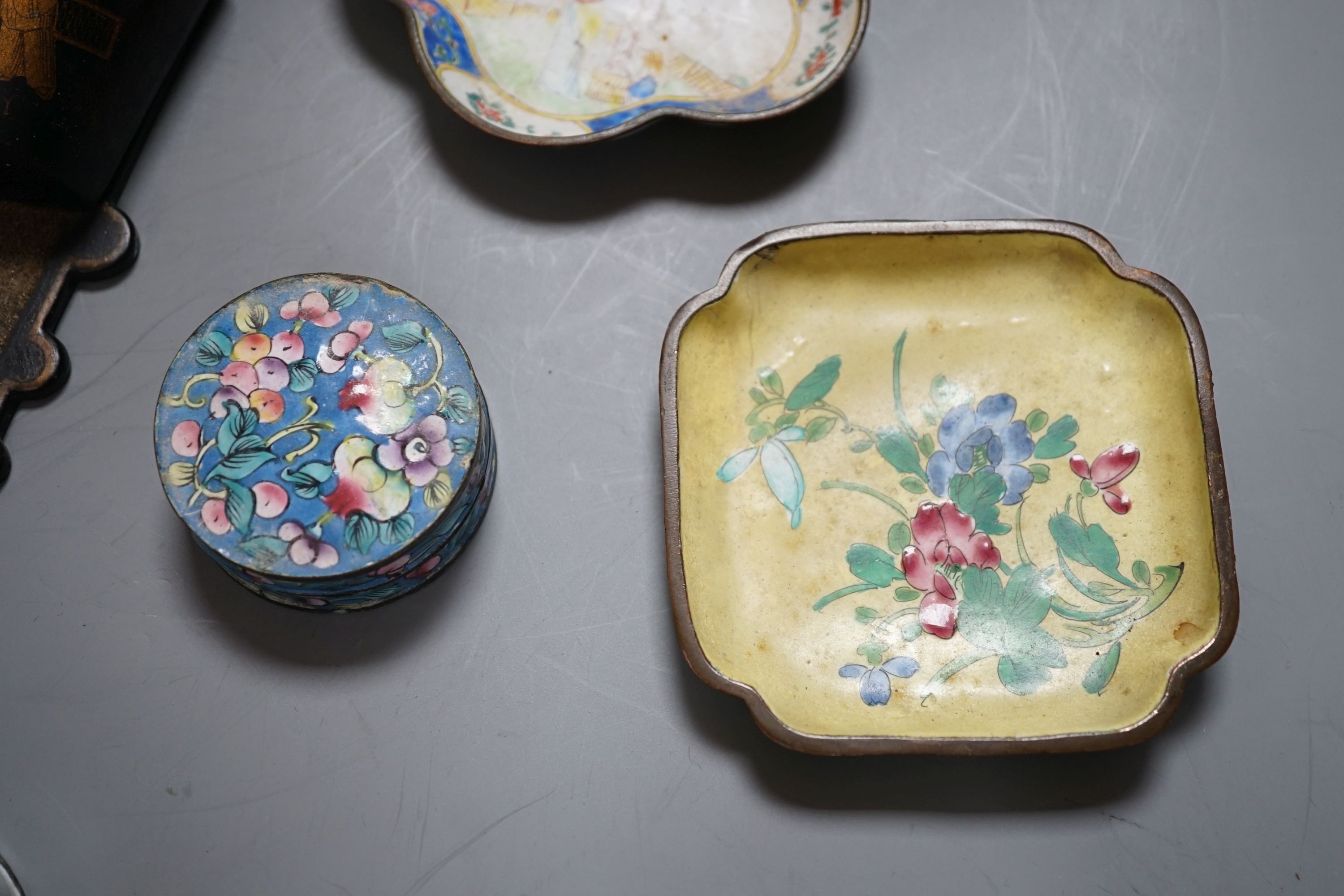 A group of five Chinese lacquered papier mache wall pockets, enamelled dishes, etc.